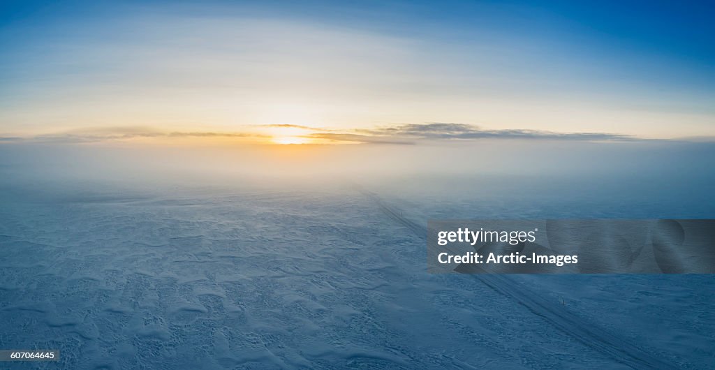 Fog and sunset over snowy road, Iceland