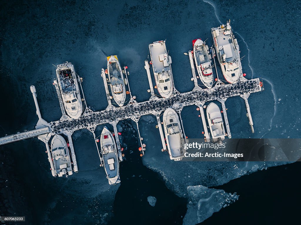 Aerial of boats in frozen harbor, Iceland