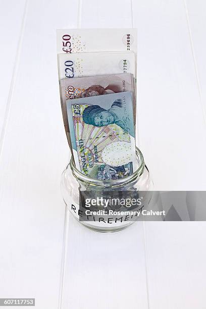 saving pound notes for retirement - 401k engels woord stockfoto's en -beelden