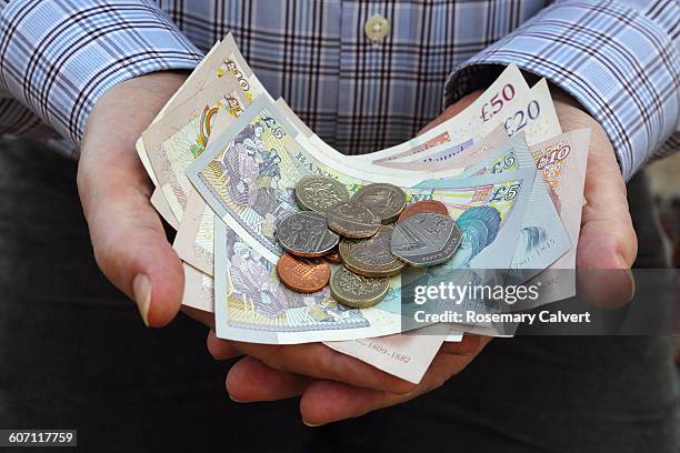 british currency in senior male's hands - old money stock-fotos und bilder