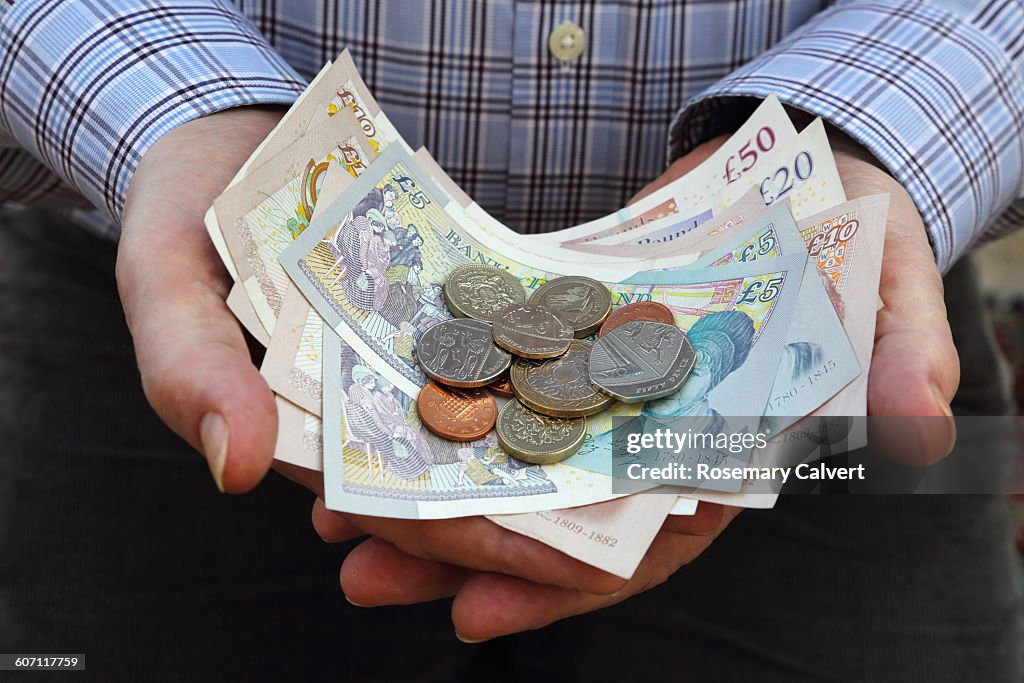 British currency in senior male's hands