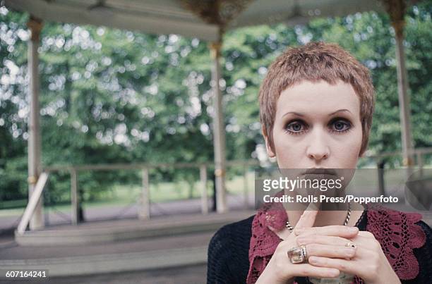 English singer Julie Driscoll pictured standing in front of a band stand in Hyde Park, London in 1968.