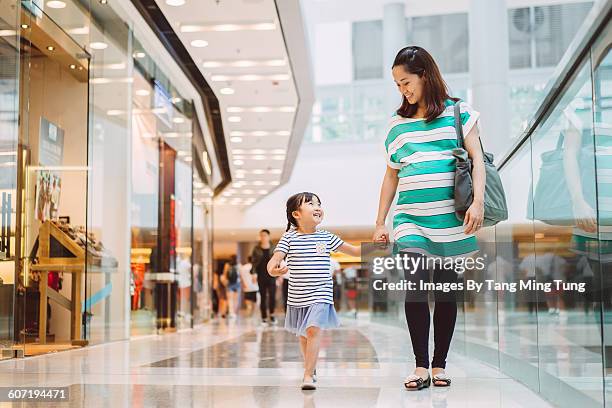 daughter & mom strolling in shopping mall - asian family shopping foto e immagini stock