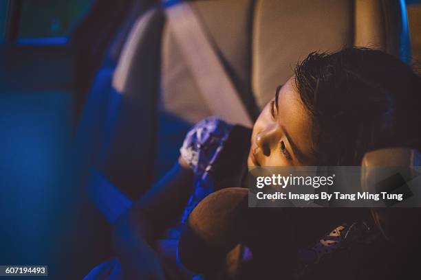 little girl resting in car - chinese dolls stock pictures, royalty-free photos & images