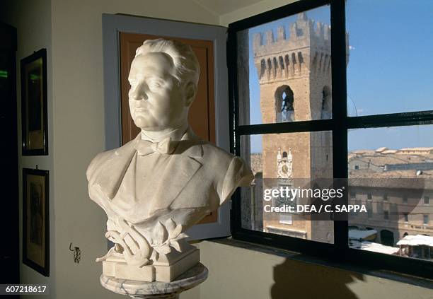 Marble bust of Beniamino Gigli , with the Civic tower in the background, Recanati, Marche, Italy.