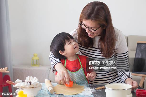 mother and son baking together. - asian mother cooking imagens e fotografias de stock