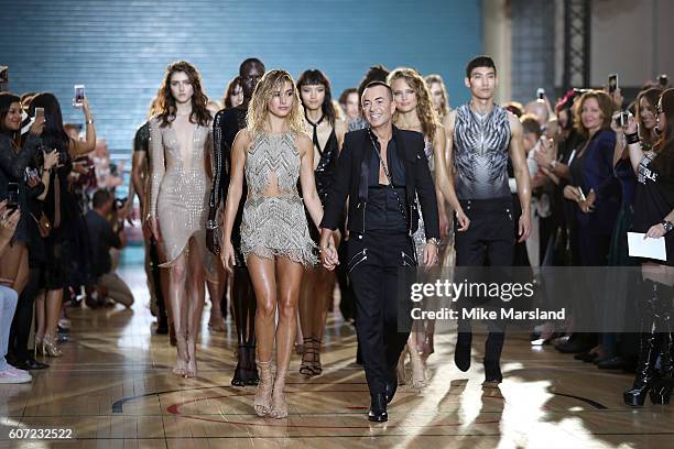 Model Hailey Baldwin walks with designer Julien Macdonald on the runway at the Julien Macdonald show during London Fashion Week Spring/Summer...