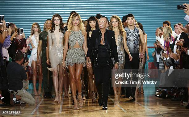 Designer Julien Macdonald surrounded by models during the finale on the runway at the Julien Macdonald show during London Fashion Week Spring/Summer...