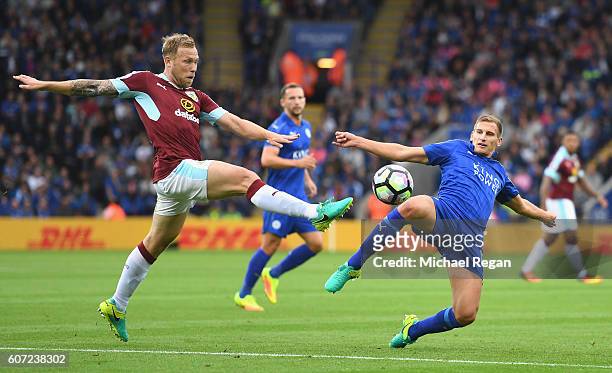 Scott Arfield of Burnley and Daniel Drinkwater of Leicester CiDaniel Drinkwater of Leicester City both stretch to reach to the ball during the...