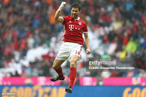 Xabi Alonso of Muenchen celebrates scoring the 2nd team goal during the Bundesliga match between Bayern Muenchen and FC Ingolstadt 04 at Allianz...