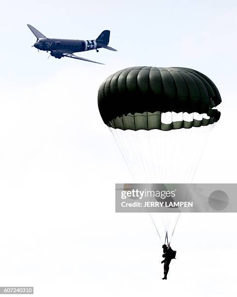 Paratroopers from the Netherlands, Belgium, Britain, Canada, Germany and the USA drop from an airplane above Ginkelse Heide, the Netherlands, on...