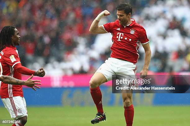 Xabi Alonso of Muenchen celebrates scoring the 2nd team goal with his team mate Renato Sanches during the Bundesliga match between Bayern Muenchen...