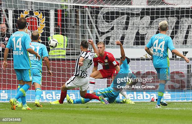 Alexander Meier of Frankfurt scores his team's first goal past goalkeeper Bernd Leno of Leverkusenduring the Bundesliga match between Eintracht...