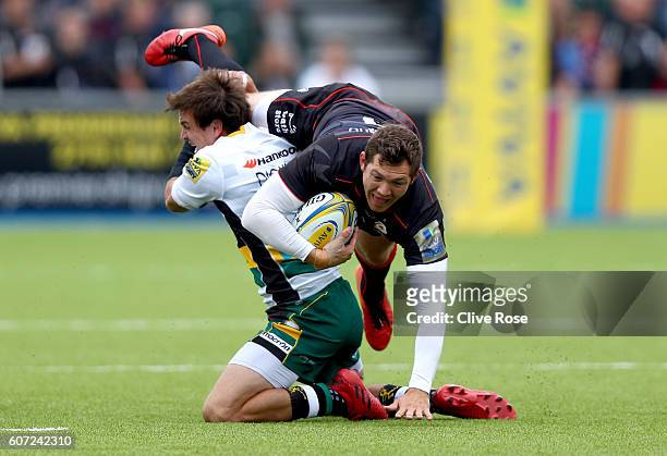Alex Goode of Saracens is tackled by Lee Dickson of Northampton Saints during the Aviva Premiership match between Saracens and Northampton at Allianz...