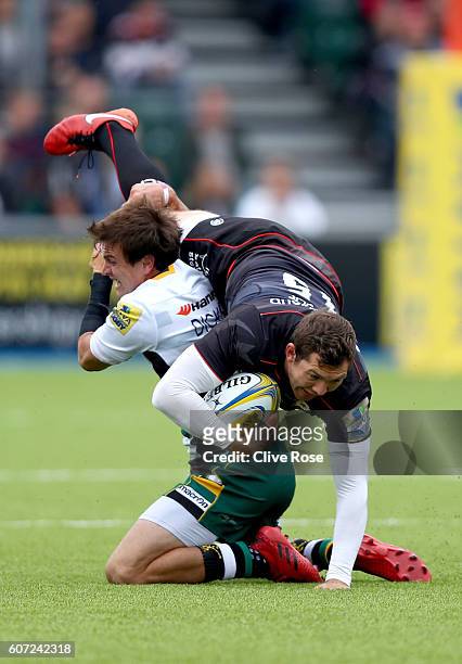 Alex Goode of Saracens is tackled by Lee Dickson of Northampton Saints during the Aviva Premiership match between Saracens and Northampton at Allianz...