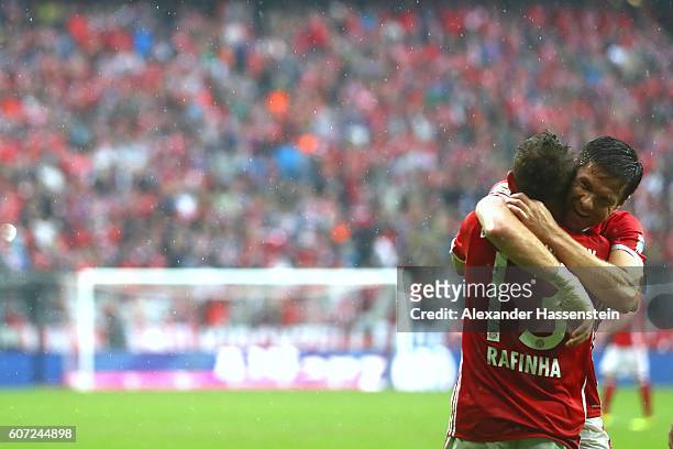 Rafinha of Muenchen celebrates scoring the 3rd team goal with his team mate Xabi Alonso during the Bundesliga match between Bayern Muenchen and FC...