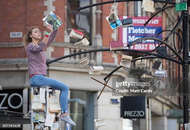 Performer entertains members of the public in the centre of Cardiff as part of a street performance to mark the start of City of the Unexpected, a...