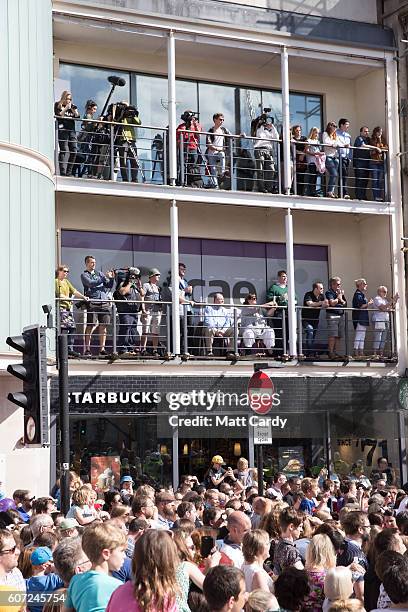 Members of the public gather to watch a giant peach as it is moved through the centre of Cardiff as part of a street performance to mark the start of...