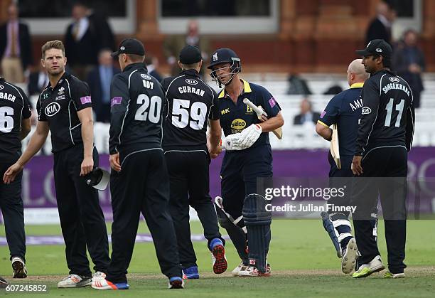 Jonathan Trott of Warwickshire is congratulated by Surrey players during the Royal London one-day cup final between Warwickshire and Surrey at Lord's...