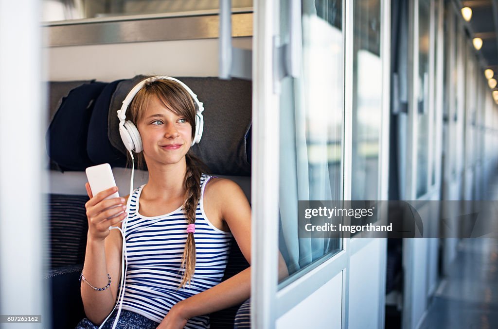 Teenage girl travelling on train in Italy