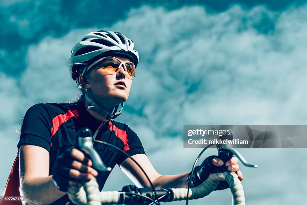 Professional female bike rider rides bicycle