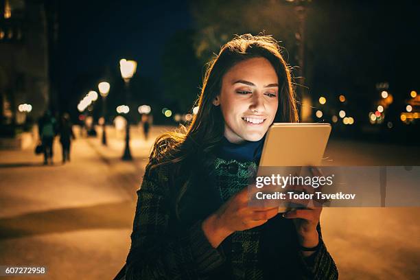 woman using tablet at night - browsing the internet stock pictures, royalty-free photos & images