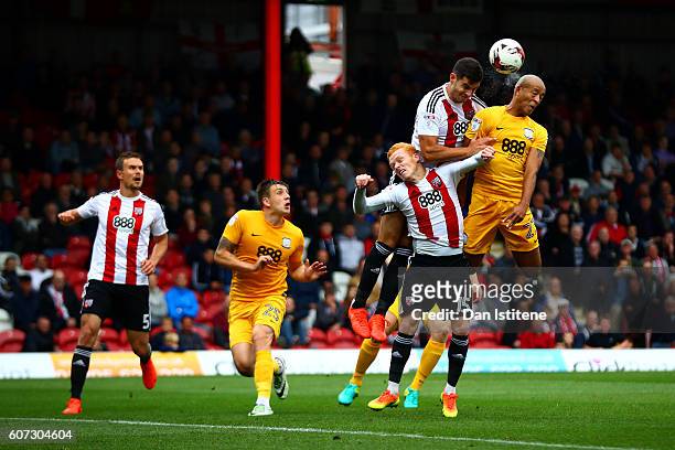 Alex John-Baptiste of Preston North End jumps for the ball with Ryan Woods and during the Sky Bet Championship match between Brentford and Preston...
