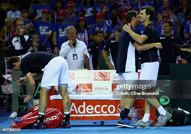 Jamie Murray of Great Britain celebrates his four set victory with his team captain Leon Smith against Juan Martin Del Potro and Leonardo Mayer of...