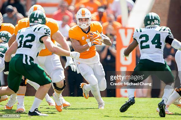Running back Jalen Hurd of the Tennessee Volunteers looks to run the ball past linebacker Quentin Poling of the Ohio Bobcats at Neyland Stadium on...