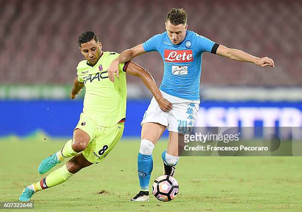 Napolis player Piotr Zielinski vies with Bologna FC player Saphir Taider during the Serie A match between SSC Napoli and Bologna FC at Stadio San...