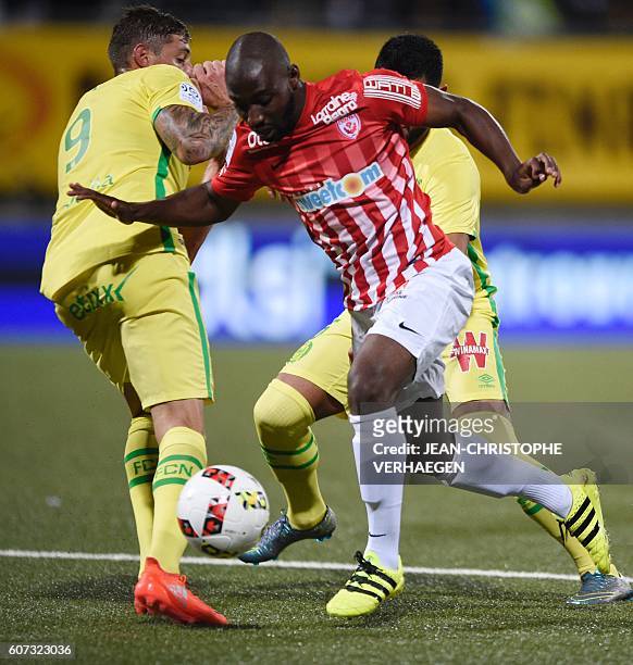 Nancy's French forward Anthony Koura vies for the ball with Nantes' Italo-Argentinian forward Emiliano Sala during the French L1 football match...