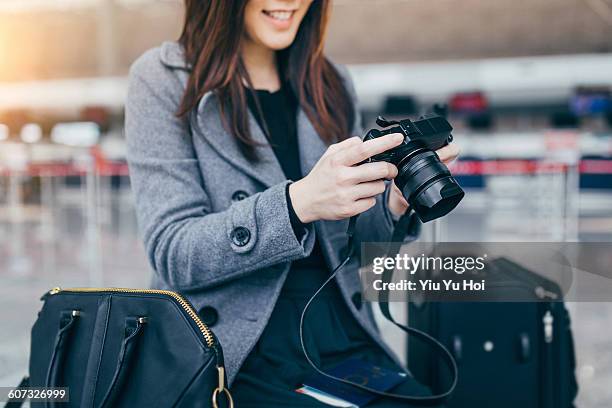 joyful woman enjoying the photos taken by camera - yiu yu hoi stockfoto's en -beelden
