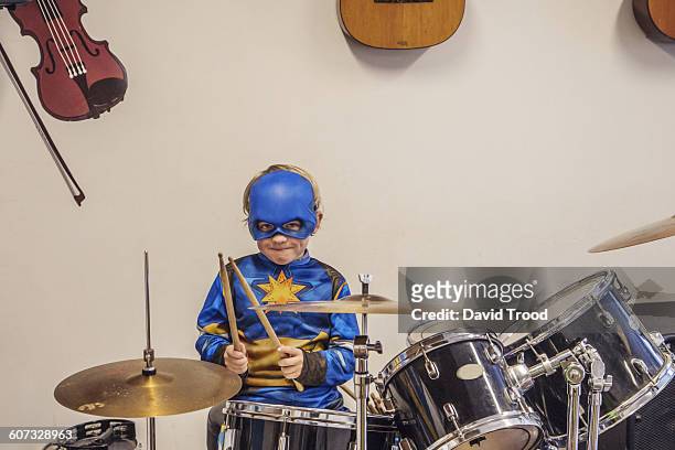 seven year old boy in costume playing drums - boy violin stockfoto's en -beelden