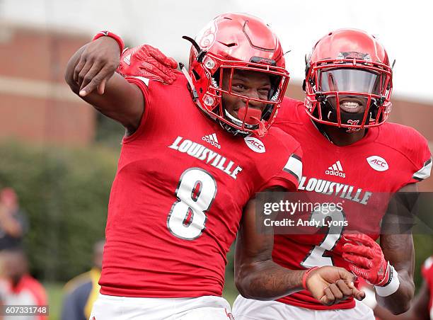 Lamar Jackson of the Louisville Cardinals celebrates with Jamari Staples after he ran for a touchdown against the Florida State Seminoles at Papa...