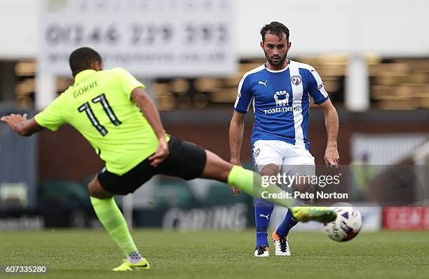 Sam Hird of Chesterfield plays the ball past Kenji Gorre of Northampton Town during the Sky Bet League One match between Chesterfield and Northampton...
