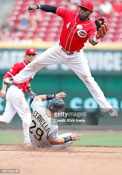 Brandon Phillips of the Cincinnati Reds is unable to catch the ball as Francisco Cervelli of the Pittsburgh Pirates safely slides into second base...