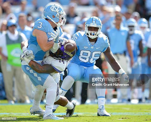 Taylor Reynolds of the James Madison Dukes breaks up a pass intended for Ryan Switzer of the North Carolina Tar Heels during the game at Kenan...