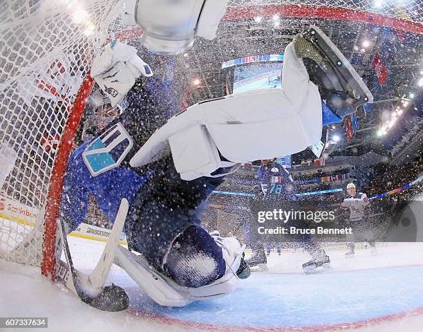 Jaroslav Halak of Team Europe is bumped by a member of Team USA during the second period during the World Cup of Hockey tournament at the Air Canada...