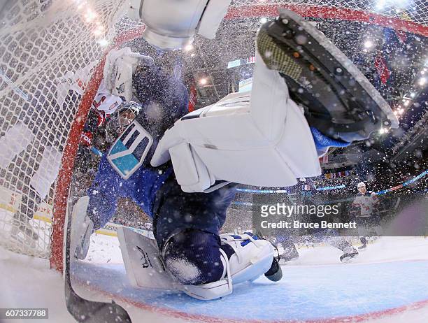 Jaroslav Halak of Team Europe is bumped by a member of Team USA during the second period during the World Cup of Hockey tournament at the Air Canada...