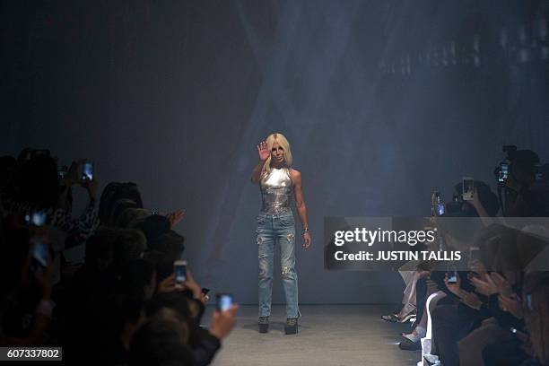 Italian designer Donatella Versace acknowledges the audience after Versace's Versus label showing during the 2017 Spring / Summer catwalk show at...
