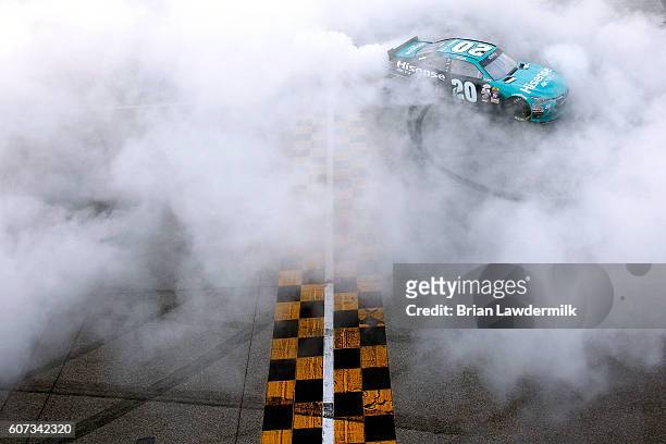 Erik Jones, driver of the Hisense Toyota, celebrates with a burnout after winning the NASCAR XFINITY Series Drive for Safety 300 at Chicagoland...