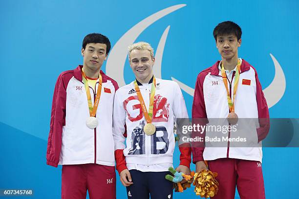 Silver medalist Song Maodang of China, Gold medalist Oliver Hynd of Great Britain and Bronze medalist Xu Haijiao of China pose on the podium at the...