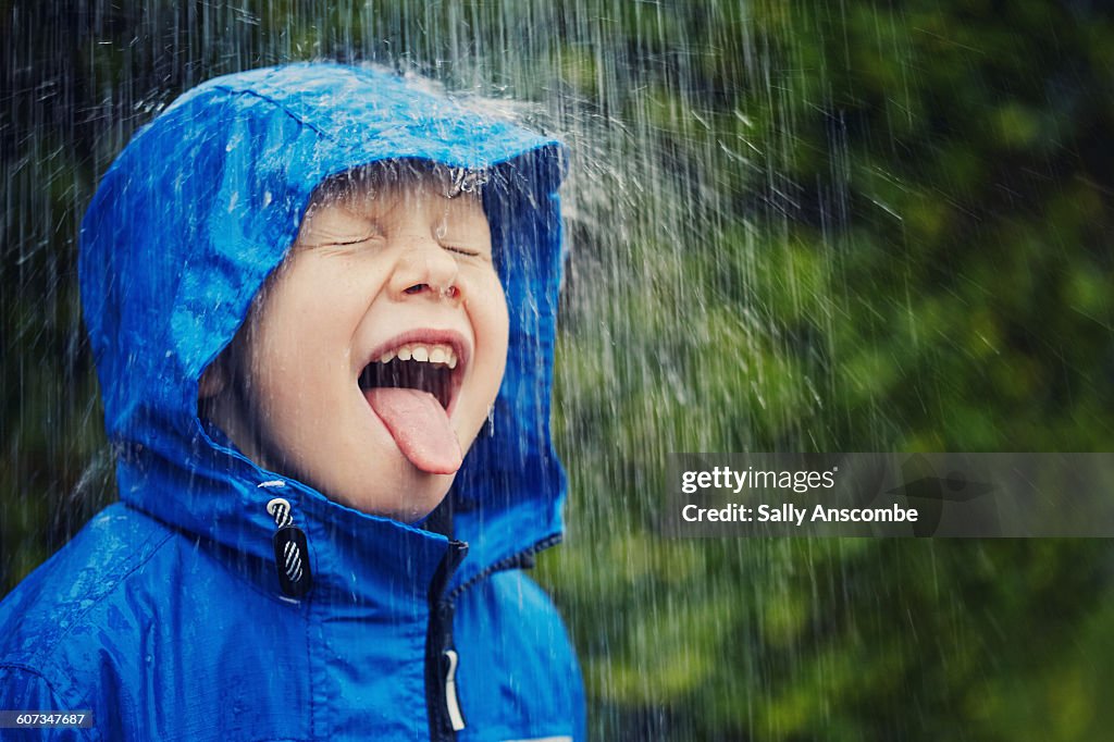 Child outdoors in the rain