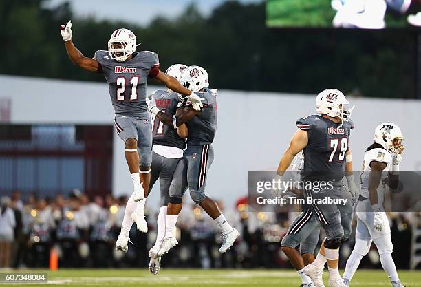 Khary Bailey-Smith of the Massachusetts Minutemen celebrates with teammates after the Minutemen forced a turnover on downs during the fourth quarter...
