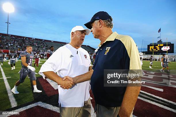 Head coach Mark Whipple of the Massachusetts Minutemen shakes hands with head coach Ron Turner of the FIU Golden Panthers after the Minutemen...