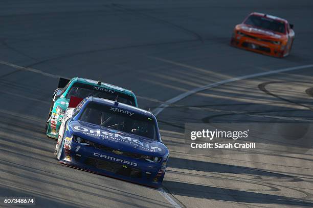 Elliott Sadler, driver of the OneMain Chevrolet, leads Erik Jones, driver of the Hisense Toyota, during the NASCAR XFINITY Series Drive for Safety...