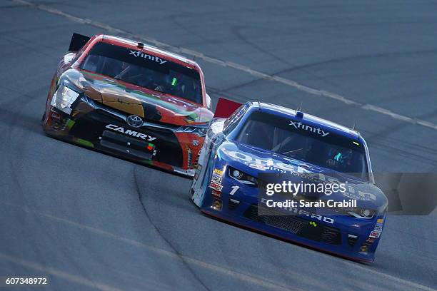 Elliott Sadler, driver of the OneMain Chevrolet, and Daniel Suarez, driver of the ARRIS/TMNT Michelangelo Toyota, race during the NASCAR XFINITY...