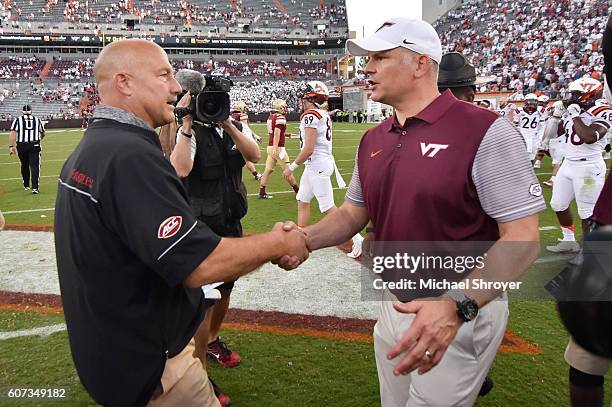 Head coach Steve Addazio the Boston College Eagles shakes hands with head coach Justin Fuente of the Virginia Tech Hokies following the game at Lane...