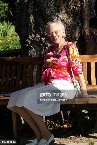 Queen Margrethe sitting on her new round bench at the old memory tree in the palace garden during the Queen's inauguration reception for her 75 years...