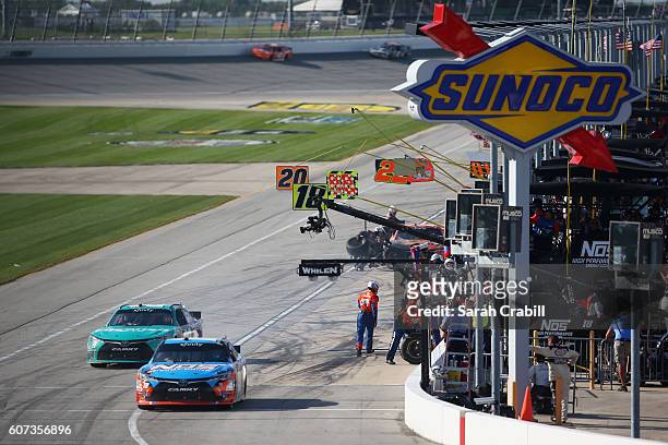 Kyle Busch, driver of the NOS Energy Drink Toyota, and Erik Jones, driver of the Hisense Toyota, leave pit road during the NASCAR XFINITY Series...